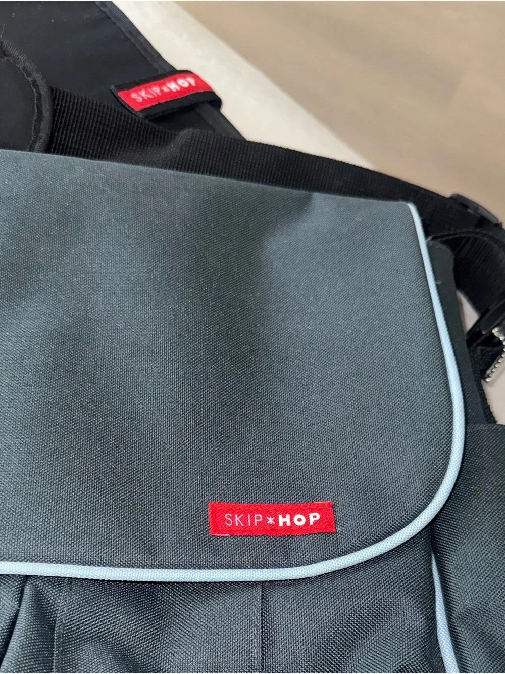 Skip Hop Black Messenger Bag with Light Blue Piping